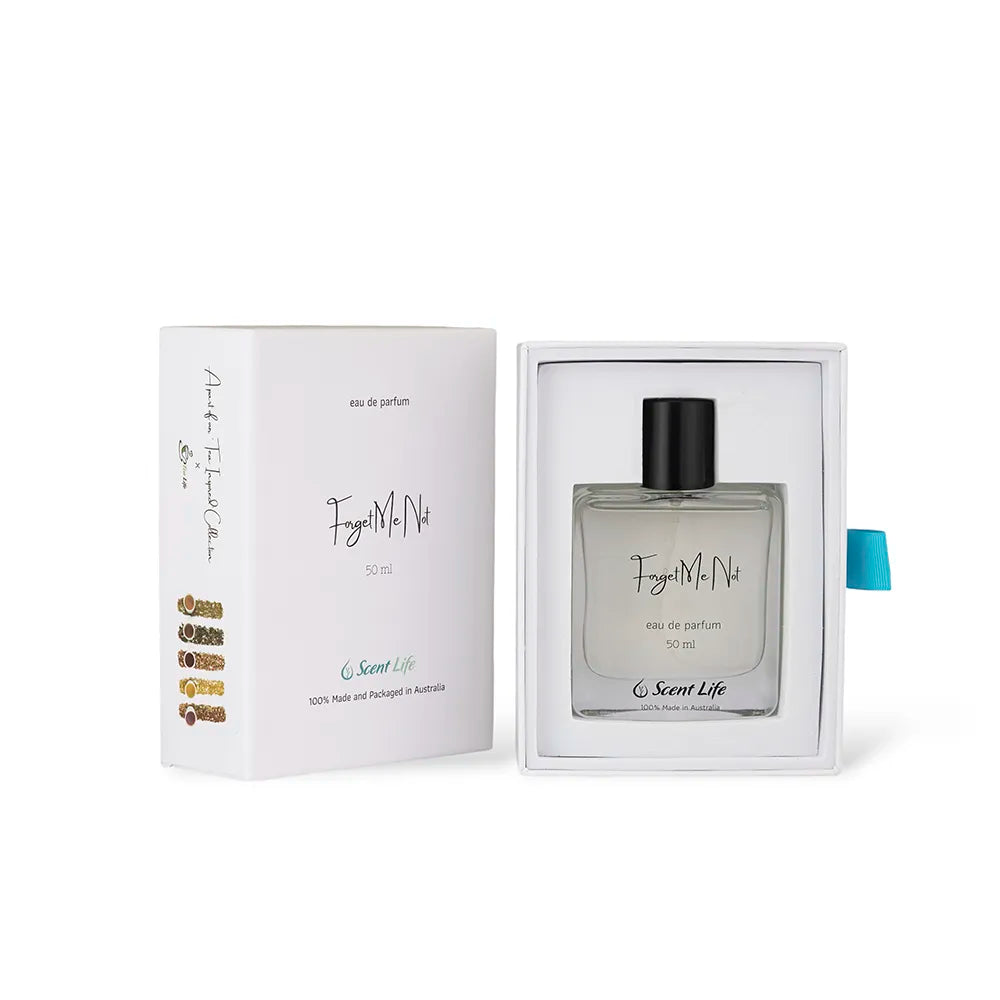 A perfume bottle labeled "Forget Me Not" by Scent Life is displayed in an open white box with the text "Feel Me Now." The bottle, equipped with a black cap, contains 50 ml of captivating Eau de Parfum featuring notes of bergamot and proudly utilizes 100% Australian ingredients and materials.