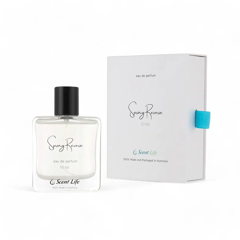 A 50 ml bottle of Scent Life's Spring Reverie Eau de Parfum is displayed gracefully next to its white packaging, featuring a distinctive blue tab. This remarkable fragrance embodies the essence of cactus flower and is entirely manufactured and packaged in Australia.