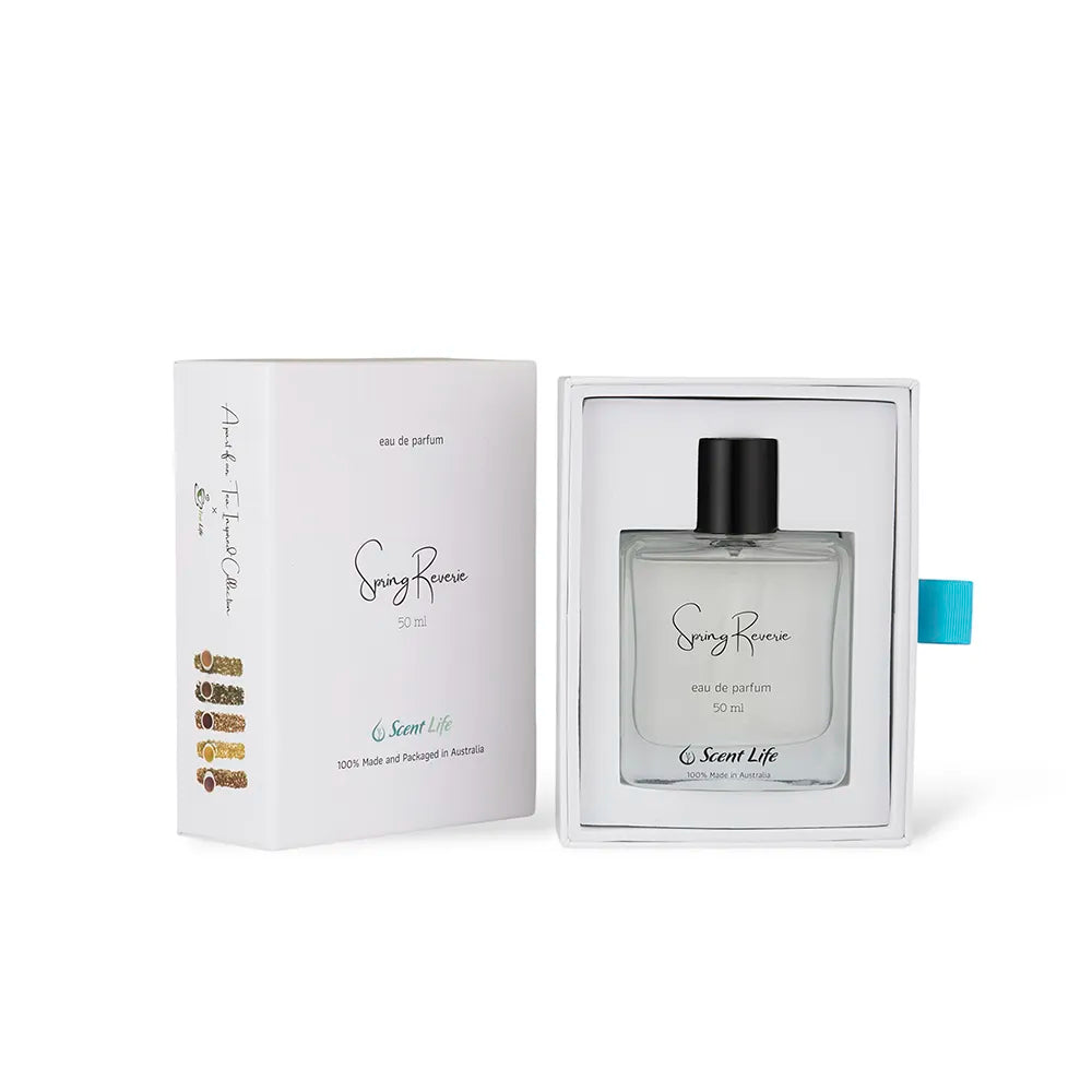 A perfume bottle labeled Spring Reverie eau de parfum by Scent Life is displayed in an open box. The packaging is white with elegant text, a turquoise ribbon, and features a hint of cactus flower design, containing 50 ml of exquisite fragrance.
