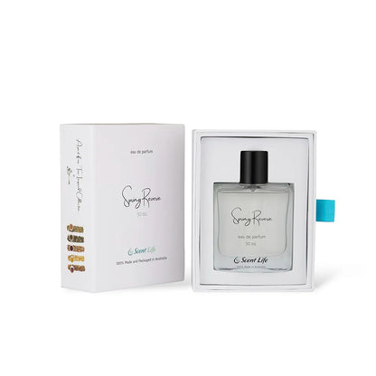 A perfume bottle labeled Spring Reverie eau de parfum by Scent Life is displayed in an open box. The packaging is white with elegant text, a turquoise ribbon, and features a hint of cactus flower design, containing 50 ml of exquisite fragrance.