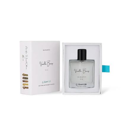 The Vanilla Breeze eau de parfum from Scent Life comes in a perfume box featuring a minimalist design with black text and a blue accent tab. The clear bottle is elegantly topped with a black cap and adorned with a simple script label, perfectly embodying the essence of this exquisite fragrance.